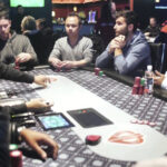 Mesa final de torneio de poker profissional, jogadores com fichas e cartas