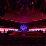 Palco iluminado de arena de eSports durante partida envolvendo a FURIA