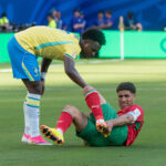 Vinícius Júnior, de amarelo, ajuda adversário marroquino caído em campo durante partida da Copa do Mundo de 2026