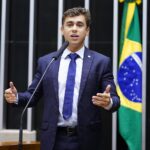 Deputado federal discursando na tribuna do plenário da Câmara dos Deputados, com a bandeira do Brasil ao fundo (Foto de arquivo do plenário da Câmara dos Deputados (2023), sem relação com o plano específico de bloqueio de recursos de bets ilegais, usada apenas para ilustrar o ambiente legislativo onde o tema foi apresentado.)
