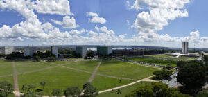 Vista aérea da Esplanada dos Ministérios em Brasília, com prédios do governo e o Congresso Nacional ao fundo
